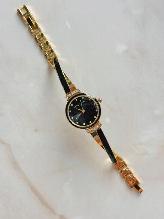 Anne Klein Quartz Watch – Black Dial with Crystal Accents & Gold-Tone Bangle Bracelet (WR 30M)