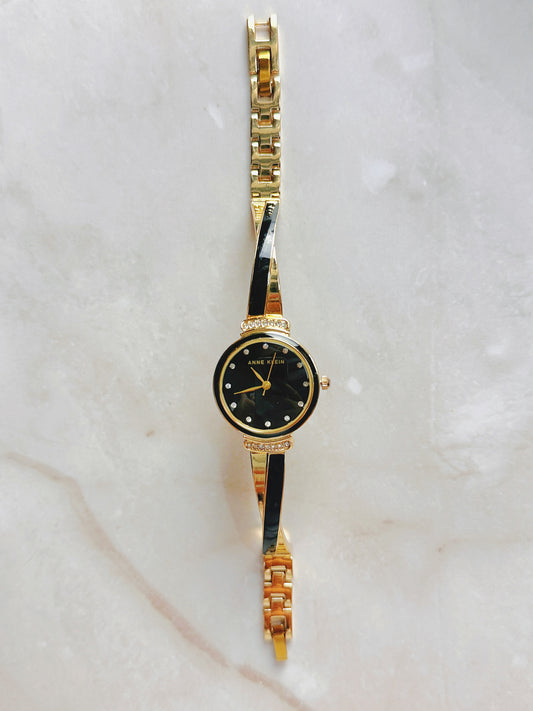 Anne Klein Quartz Watch – Black Dial with Crystal Accents & Gold-Tone Bangle Bracelet (WR 30M)