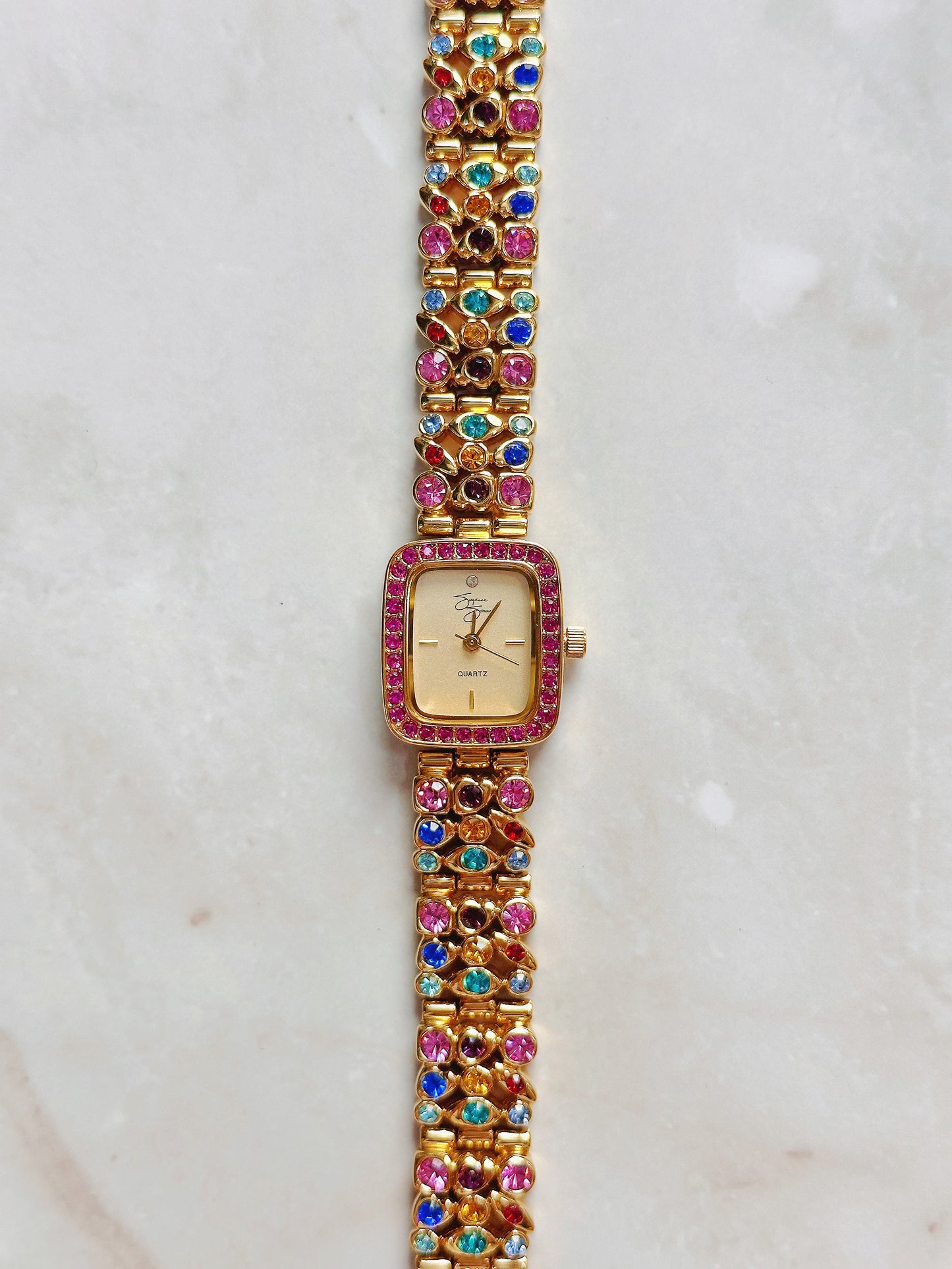 Suzanne Somers Quartz Watch – Gold Dial with Pink Crystal Bezel & Multicolor Gem Bracelet (WR 30M)