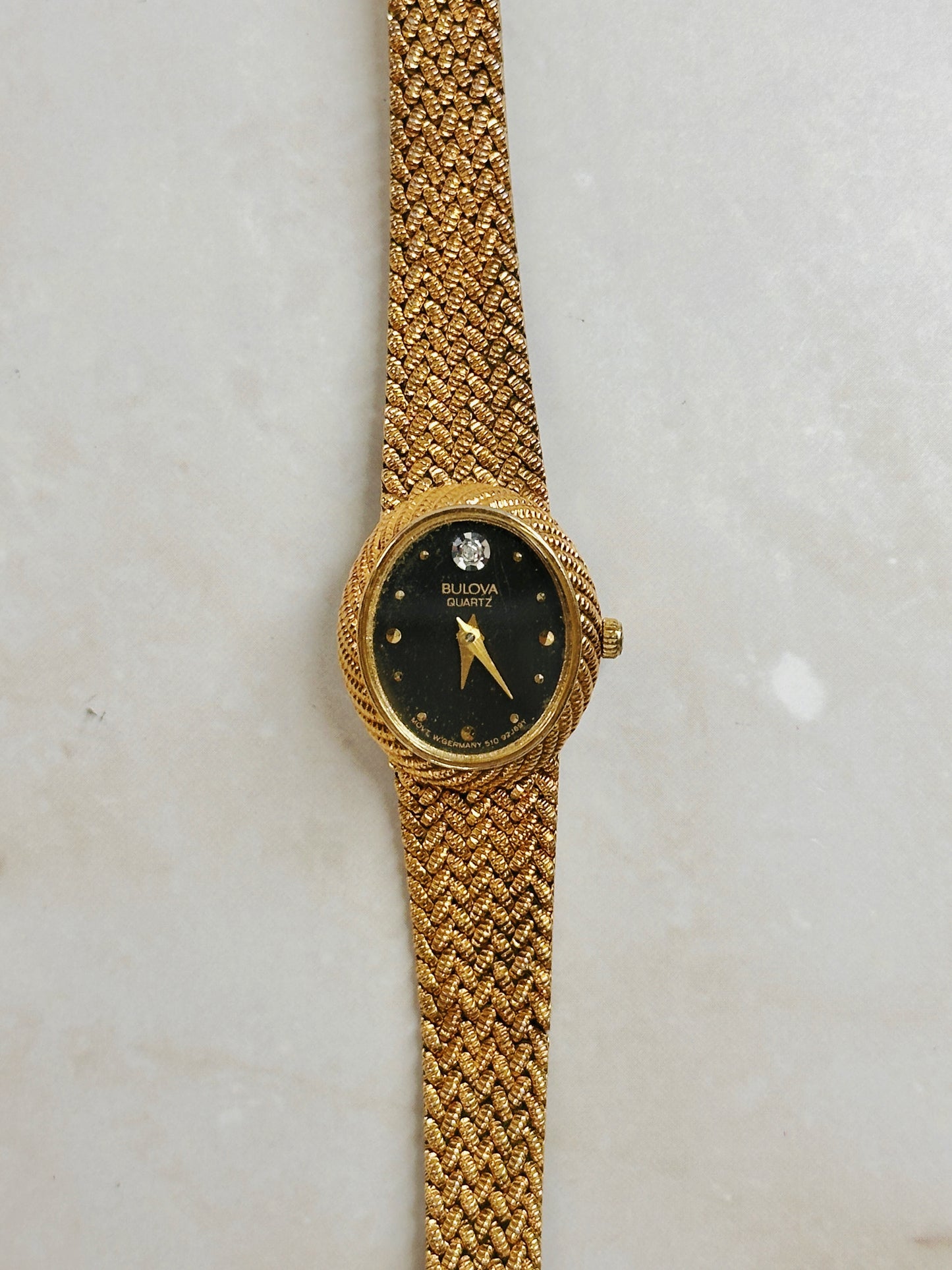 Bulova Petite Oval Gold-Tone Watch – Black Dial – Diamond Accent – Woven Bracelet