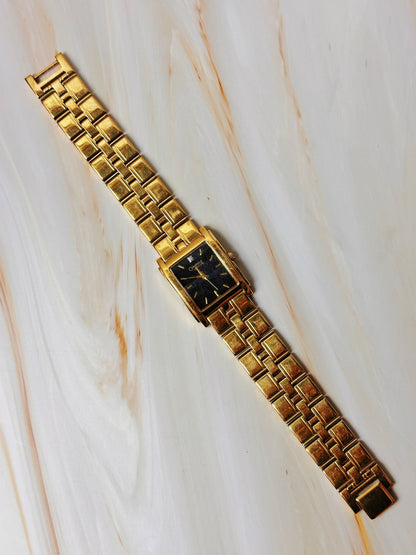 Caravelle by Bulova Women’s Gold Tone Tank Style Watch – Black Dial – Quartz Dress Watch