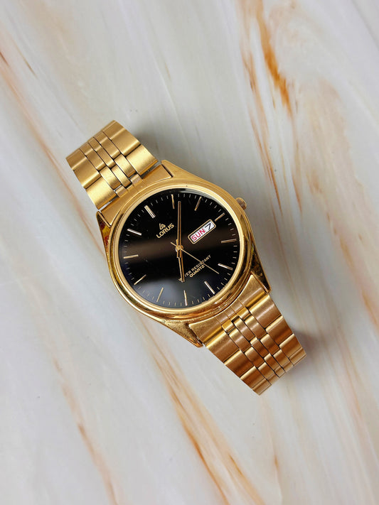 Lorus Quartz Men’s Watch – Day Date – Black Dial – Gold Tone Bracelet – Water Resistant