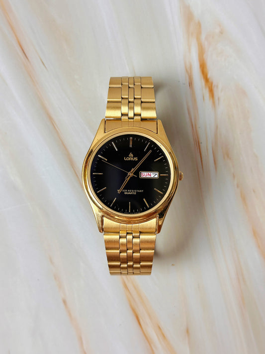 Lorus Quartz Men’s Watch – Day Date – Black Dial – Gold Tone Bracelet – Water Resistant