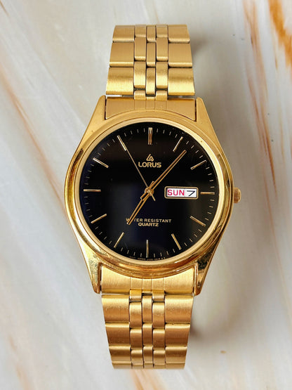 Lorus Quartz Men’s Watch – Day Date – Black Dial – Gold Tone Bracelet – Water Resistant